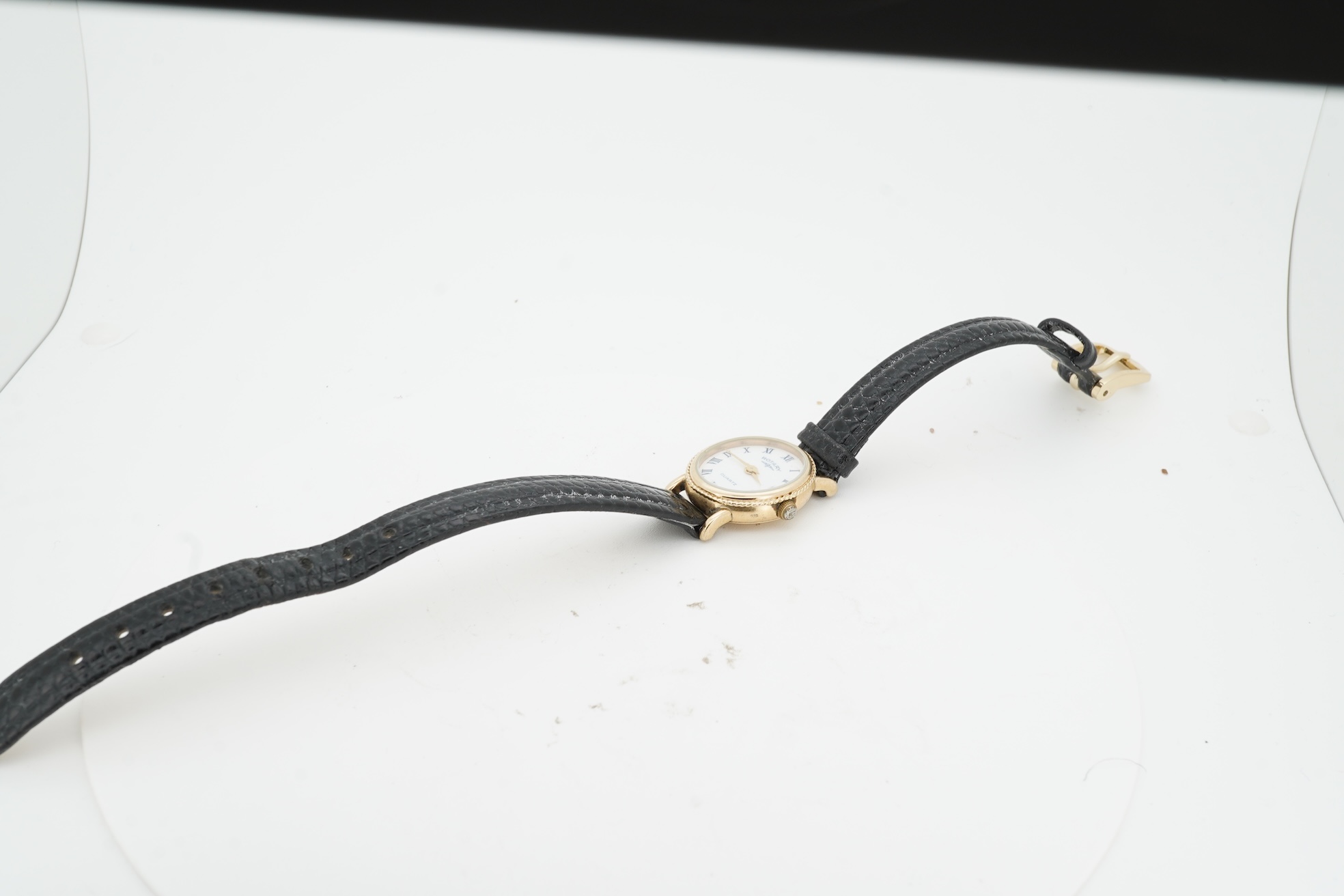 A lady's recent 9ct gold Rotary quartz wrist watch, with oval Roman dial, case diameter 18mm, on an associated leather strap, no box or papers.